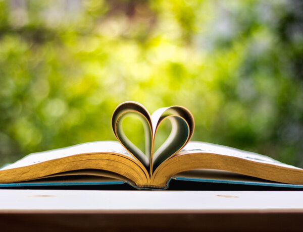 Open book with folded pages to create a heart shape